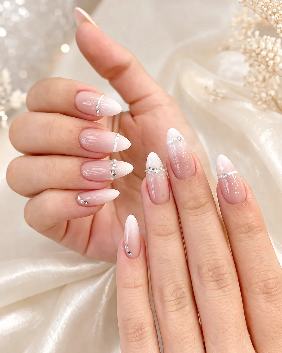 Elegant French tip Prom Nails with rhinestones at Plush Nail Bar in The Woodlands, featuring nude pink base and crystal accents