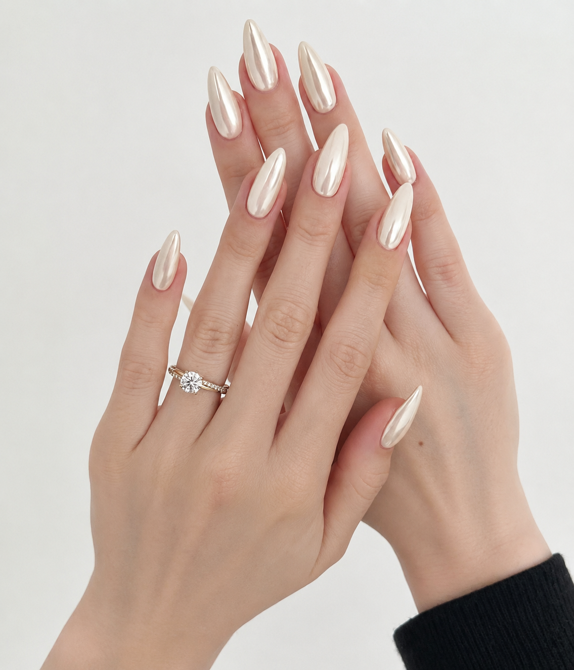 Champagne Chrome Nails with a pearl chrome finish on almond-shaped nails, creating a timeless bridal manicure with a luxurious glazed effect.