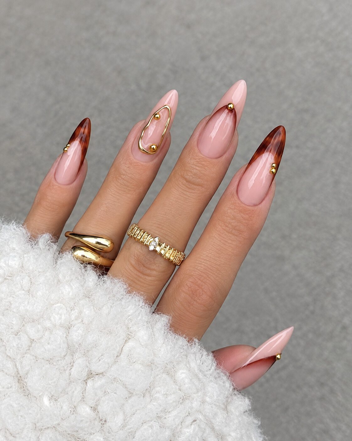 Tortoiseshell French tip almond nails with gold studs fall nail design