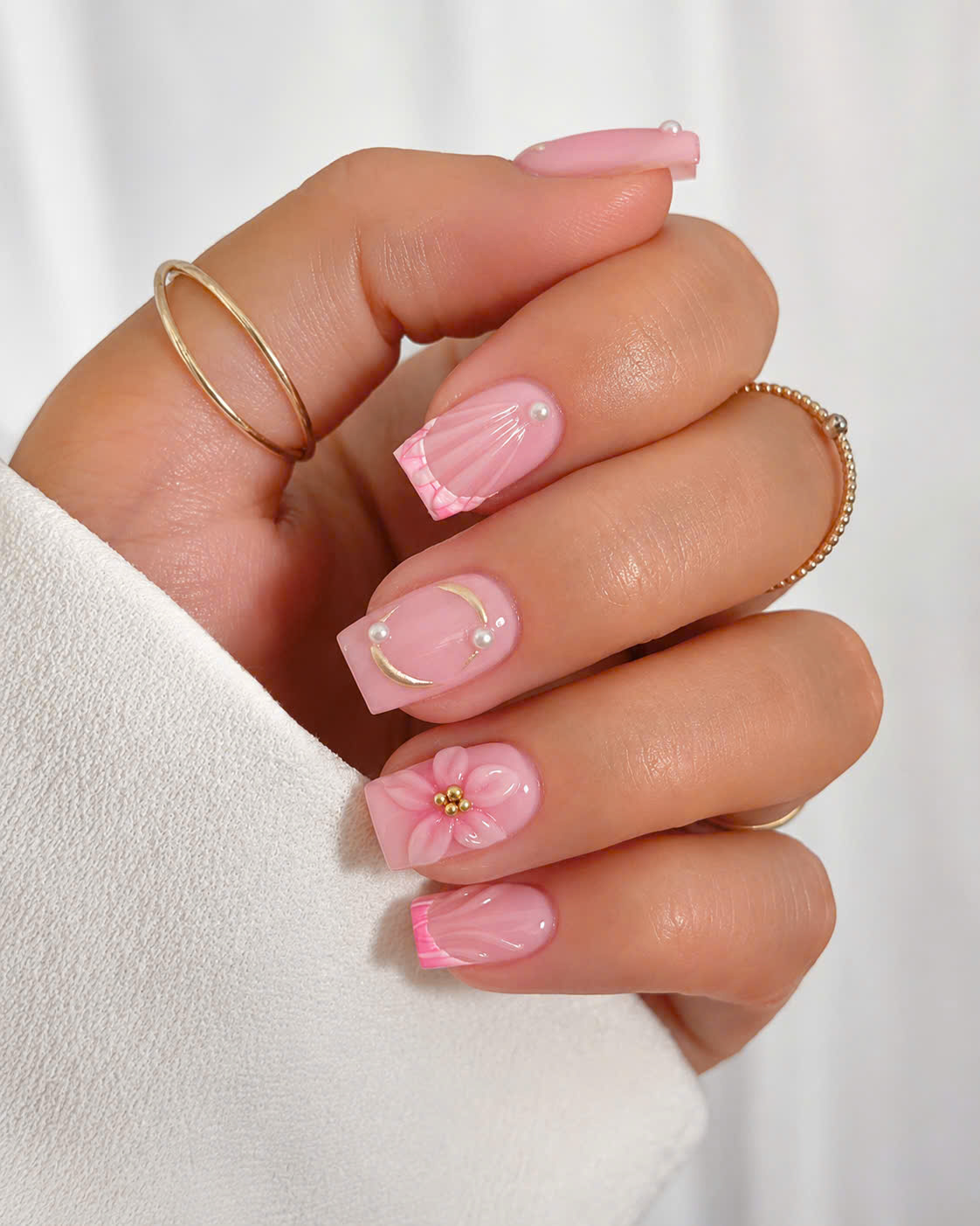 Pink seashell nail art with 3D flower accents