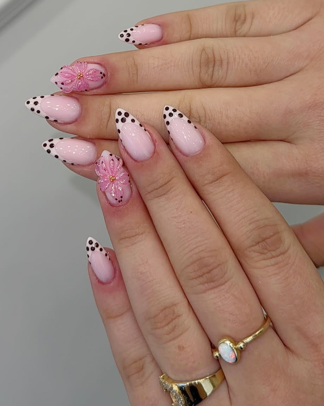 Soft pink polka dots ideas nail design with floral accent
