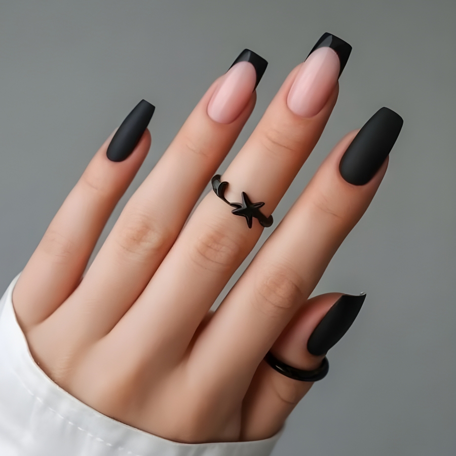 Bold matte black French manicure with a modern coffin nail shape and soft pink nude base.