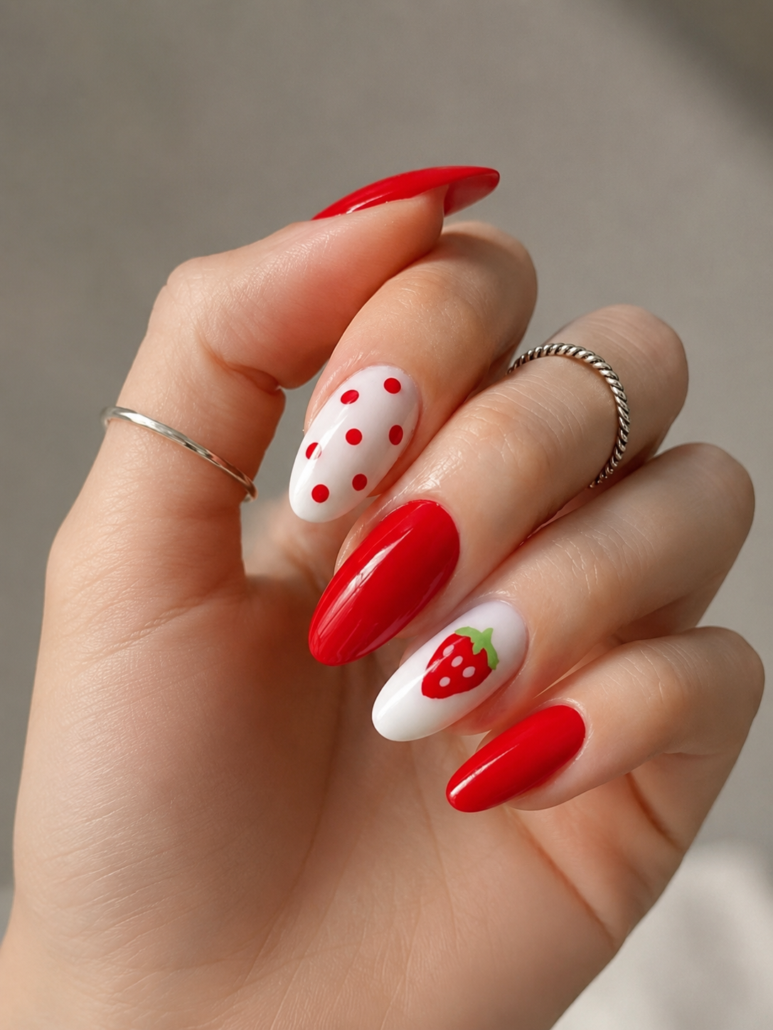 9 Trendy Strawberry Nails for a Sweet Summer in Kingwood, TX 4 Retro summer nail design with solid red nails, white and red polka dots, and a cute strawberry accent nail.