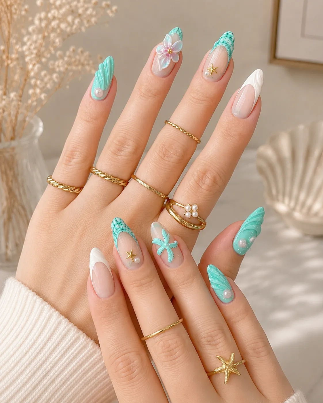 Ocean-inspired Tiffany blue nails with seashell texture pearl accents and starfish nail art