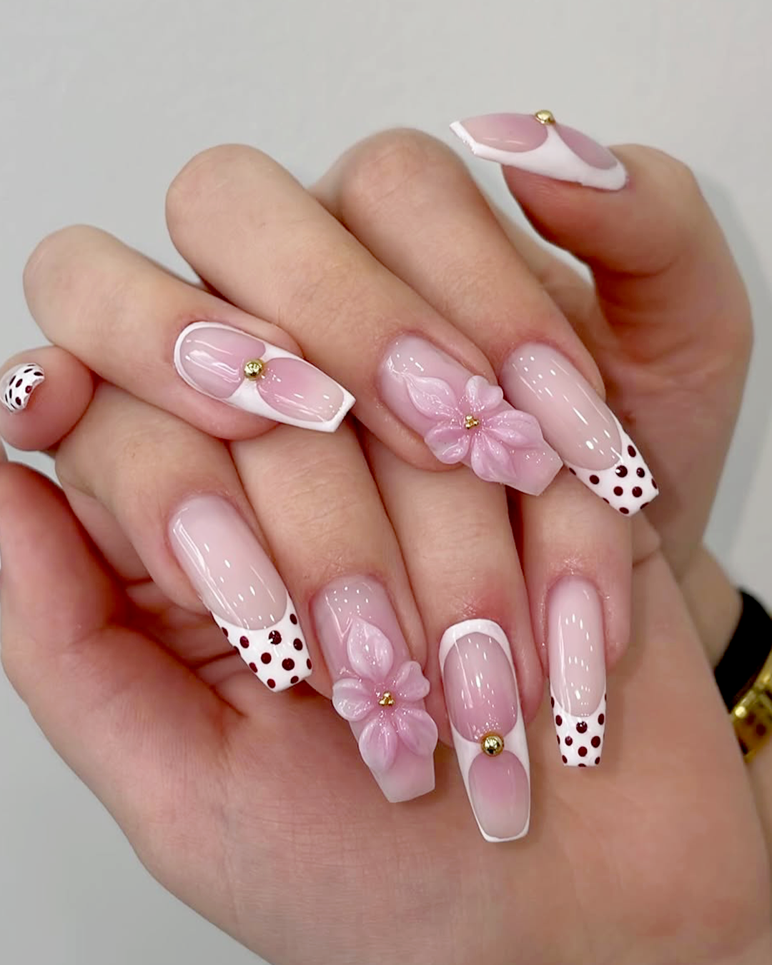 3D floral pink french nail with brown polka dots and crystal charms