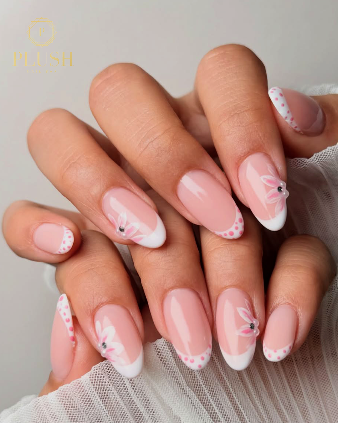 Spring Break Bliss: 4 Stunning Floral Nail Ideas That Will Instantly Elevate Your Vacation Look 4 Elegant Spring break French manicure with soft pink base, white tips, and delicate floral accents with subtle dotted detailing.