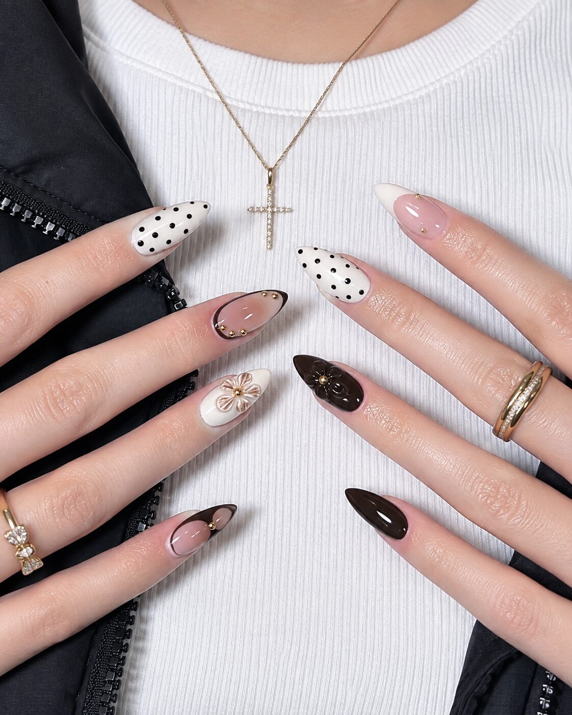 Deep chocolate brown and cream polka dot almond nails with 3D floral accents