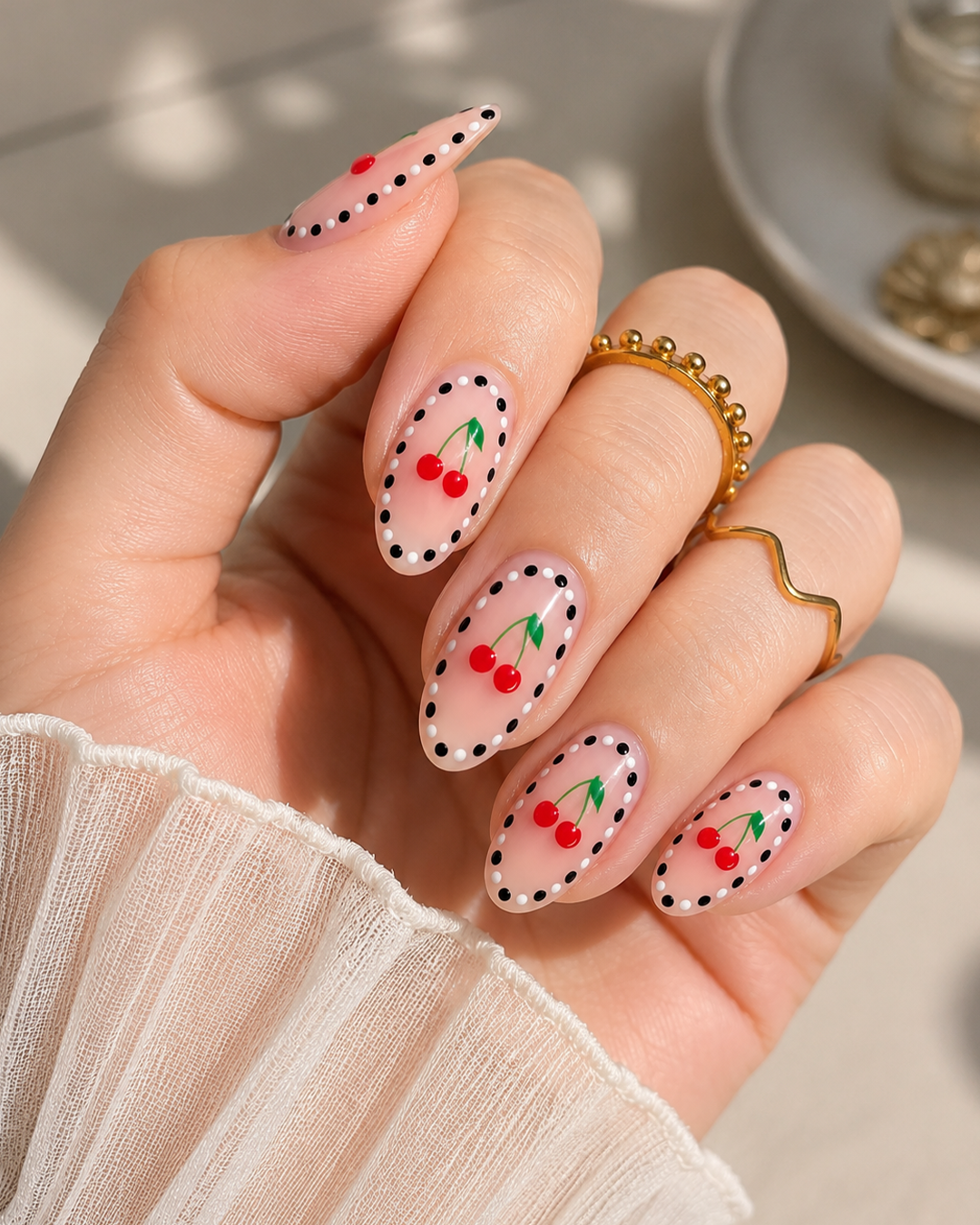 Cherry Nails Are the Sweetest Trend of the Year | 7 Chic Designs by Plush Nail Bar 6 Modern Cherry Nail Art with dotted borders, nude base, and glossy cherry illustrations.
