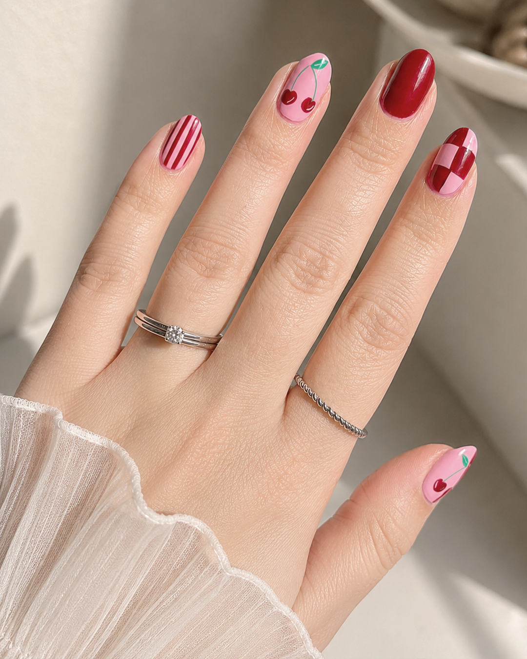 Cherry Nails Are the Sweetest Trend of the Year | 7 Chic Designs by Plush Nail Bar 5 Pink Cherry Nails featuring striped, color-blocked, and glossy cherry nail designs for everyday wear.