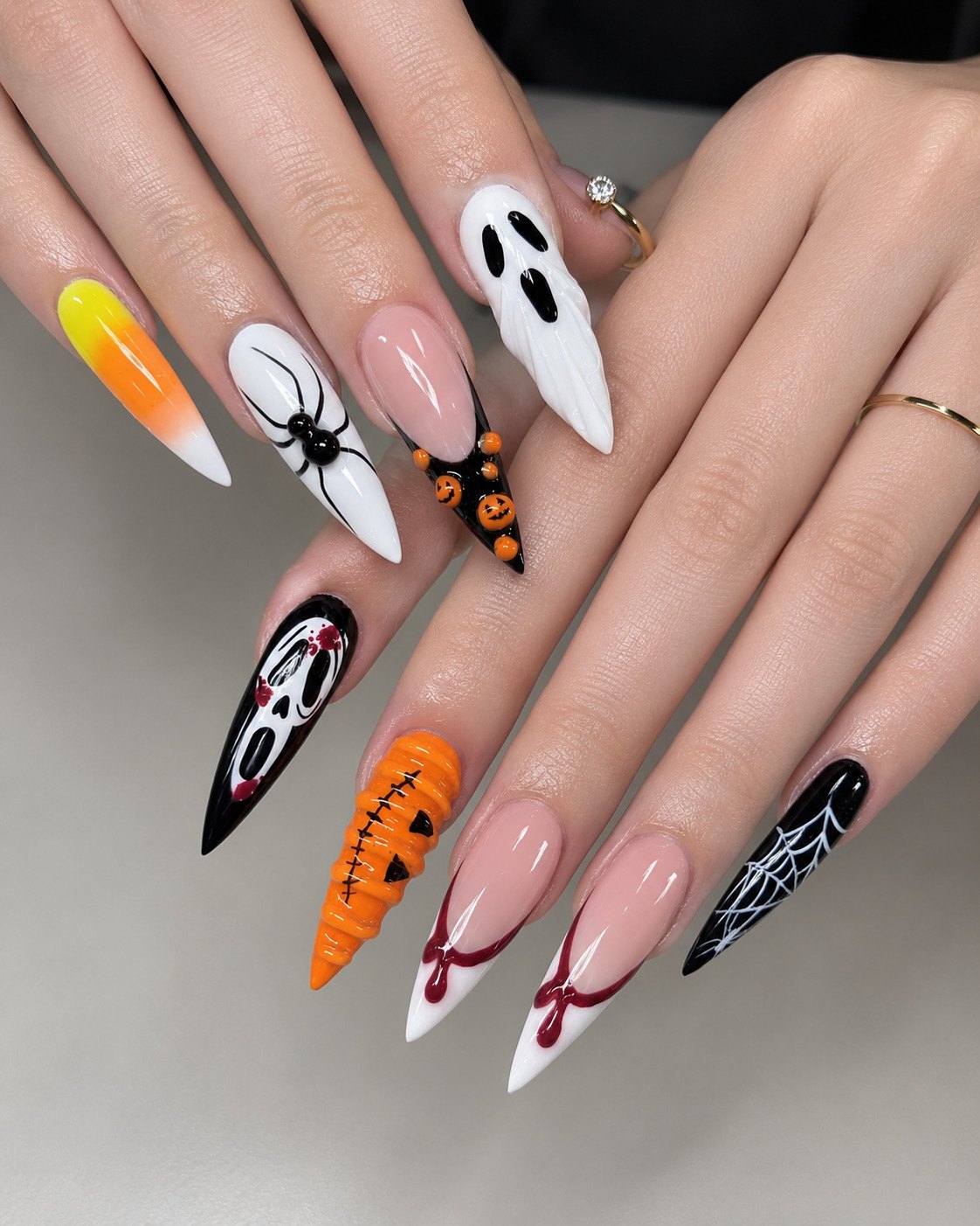 Mismatched 3D Halloween stiletto nails with candy corn, a spider, ghost, Ghostface and a pumpkin