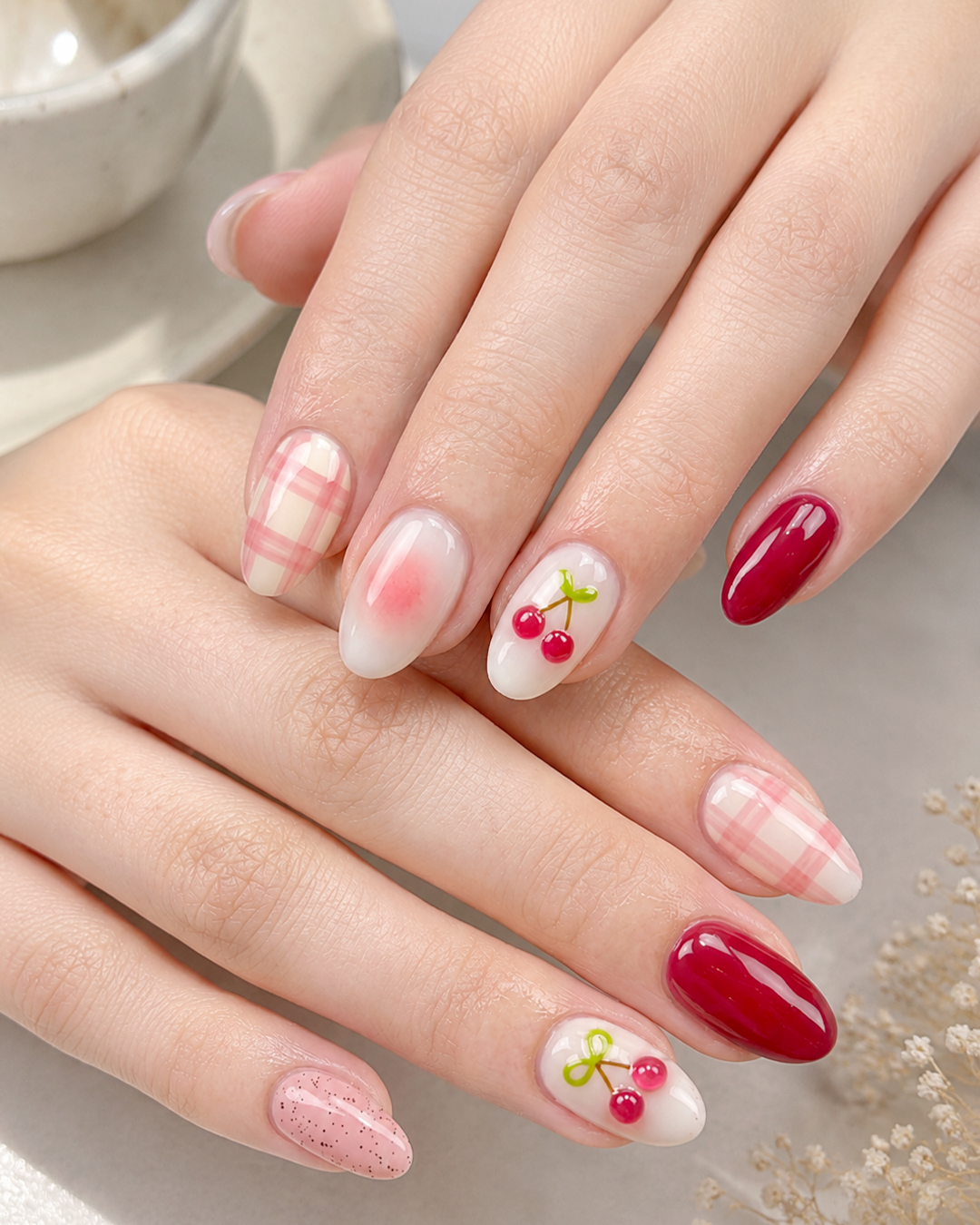 Cherry Nails Are the Sweetest Trend of the Year | 7 Chic Designs by Plush Nail Bar 7 Cherry Plaid Nails combining soft pink plaid patterns with glossy cherry nail art on almond nails.