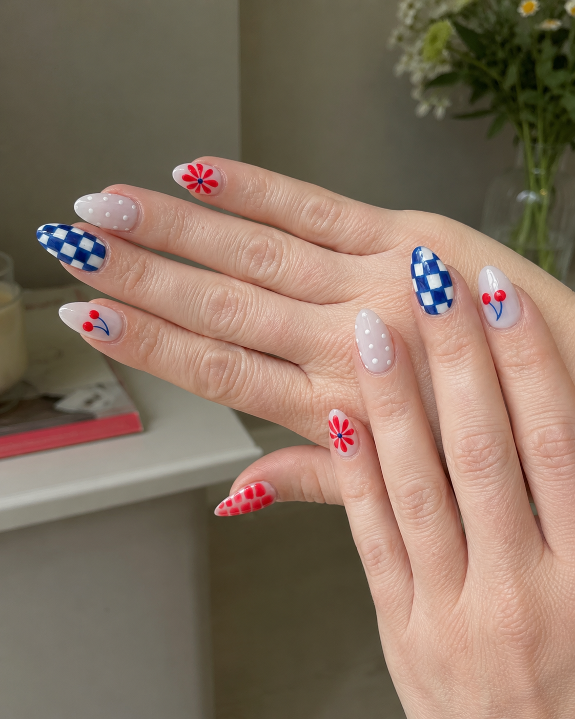 Blue gingham, cherry, and floral nail art featuring a chic summer-inspired Fourth of July manicure design.