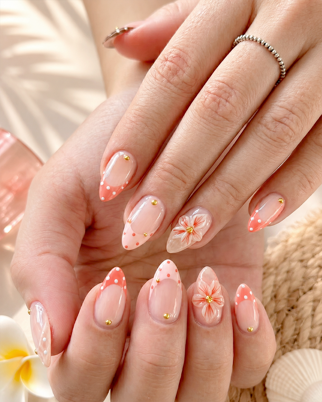 7 Flower Nail Designs for a Fresh, Feminine Manicure 3 A soft coral blossom manicure with nude bases, tiny dots, and elegant flower nail art.
Alt text: Elegant flower nail design with nude bases, coral blossom accents, tiny dotted details, and soft feminine floral art. This manicure is perfect for floral nails, simple flower nails, romantic flower nail designs, and polished flower nail art ideas.