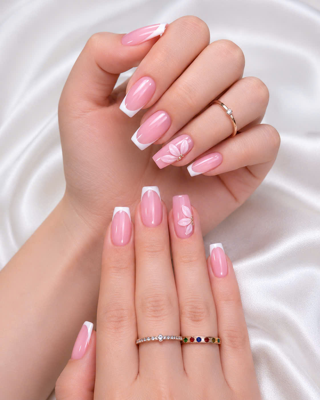 Classic pink French manicure with floral accent nail