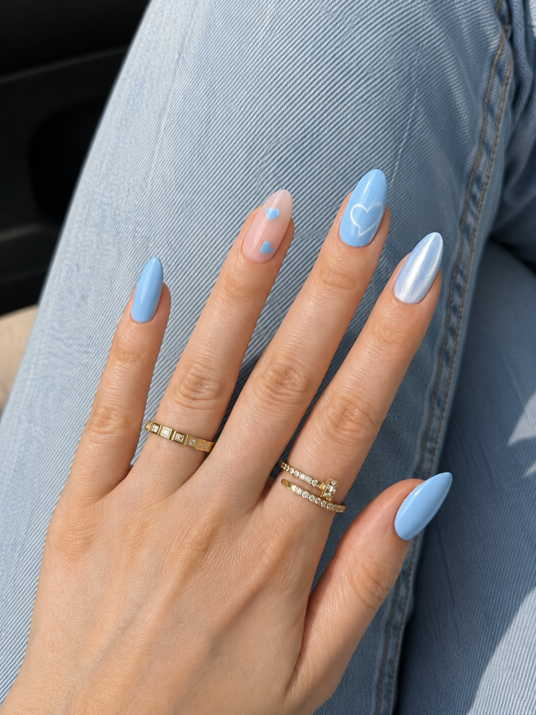 Baby Blue Nails featuring cute heart nail art on almond nails