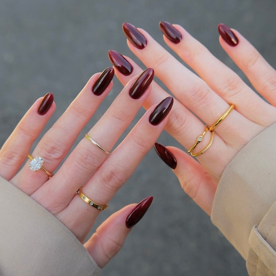 Classic glossy Burgundy manicure on almond-shaped nails, timeless deep red fall style.