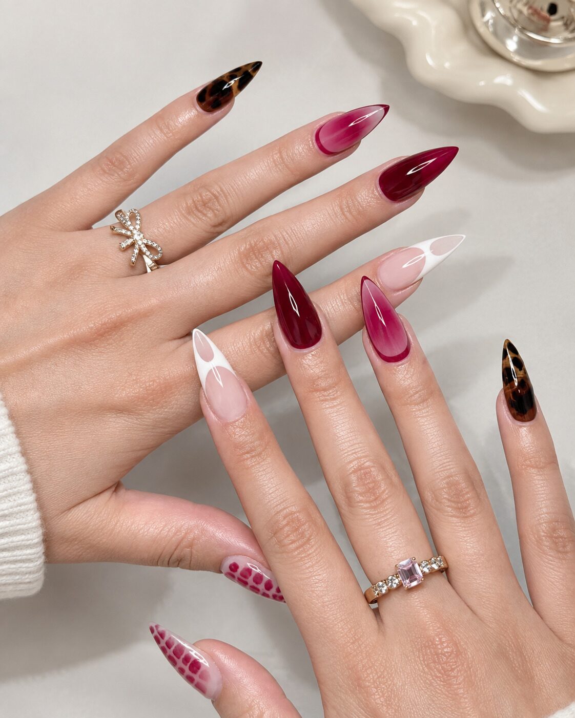 Rich burgundy red stiletto nails mixed with tortoiseshell pattern and white French tips