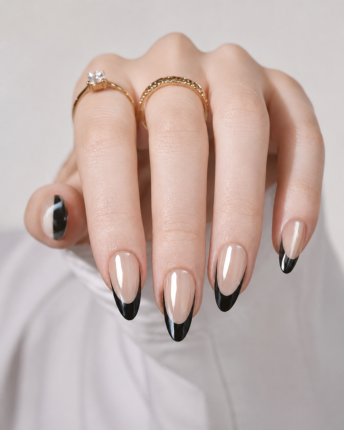 Minimalist black french nail with clean micro-tips on almond shape