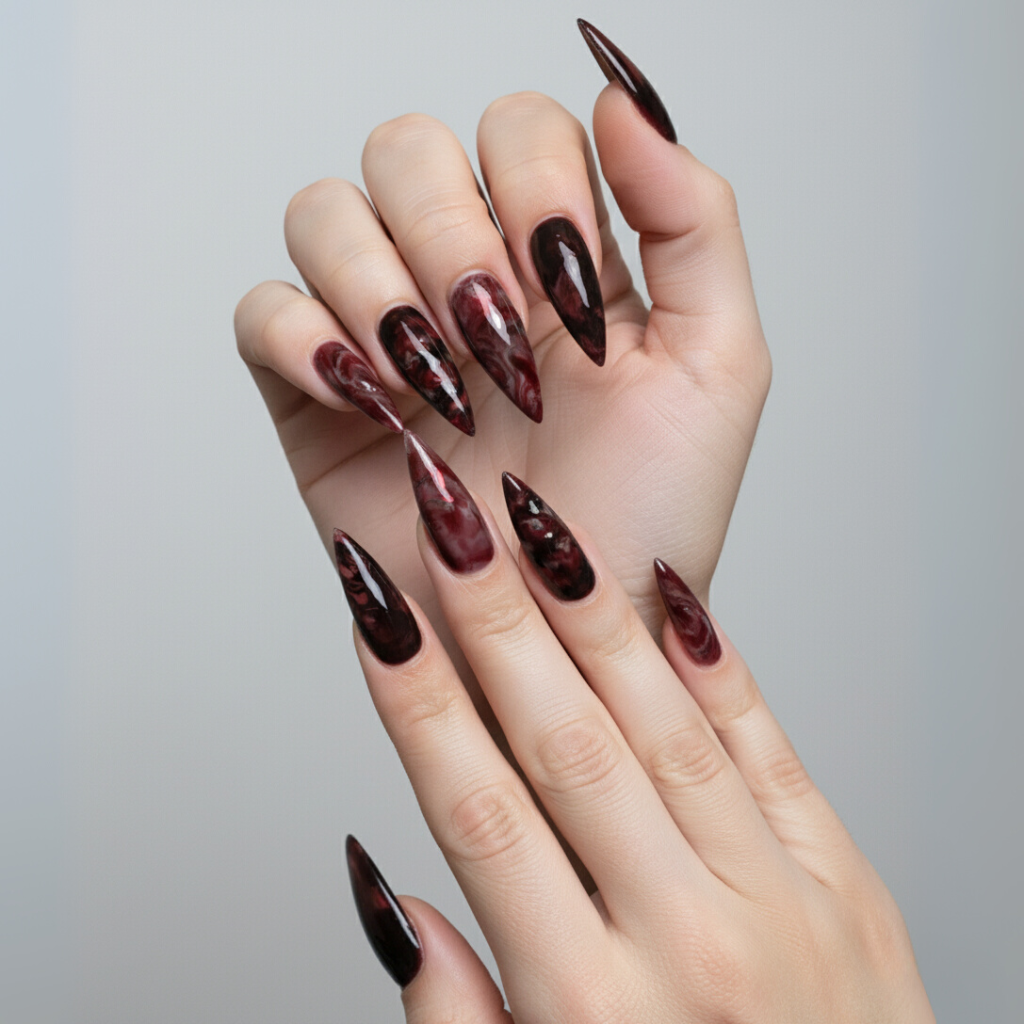 Stiletto-shaped Halloween nails in blood-red marble pattern, vampire-inspired look