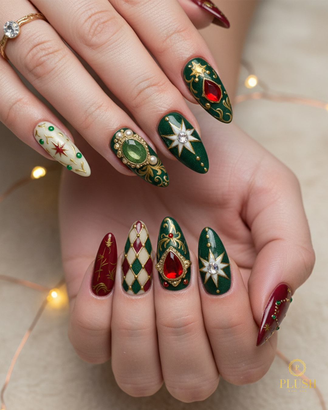 Luxurious emerald green Christmas nails with gold detailing, pearls, and gemstone accents by Plush Nail Bar.