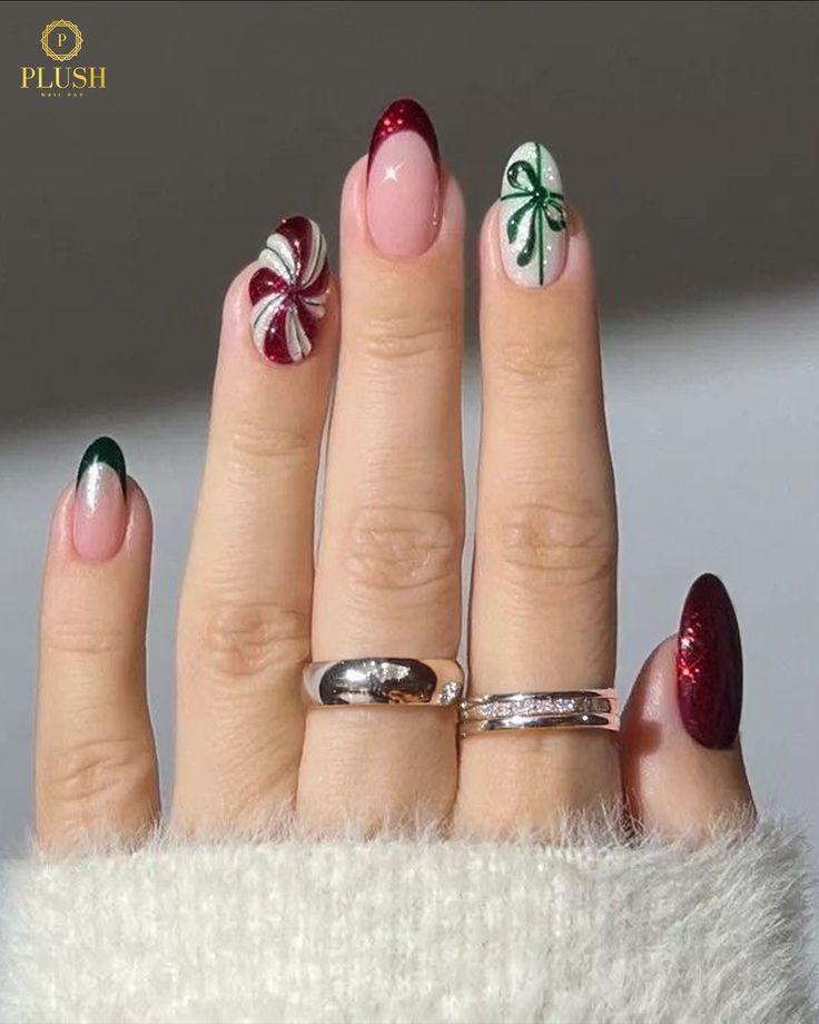 Festive Christmas nails featuring peppermint swirl art, red and green French tips, and hand-painted holiday bow designs by Plush Nail Bar