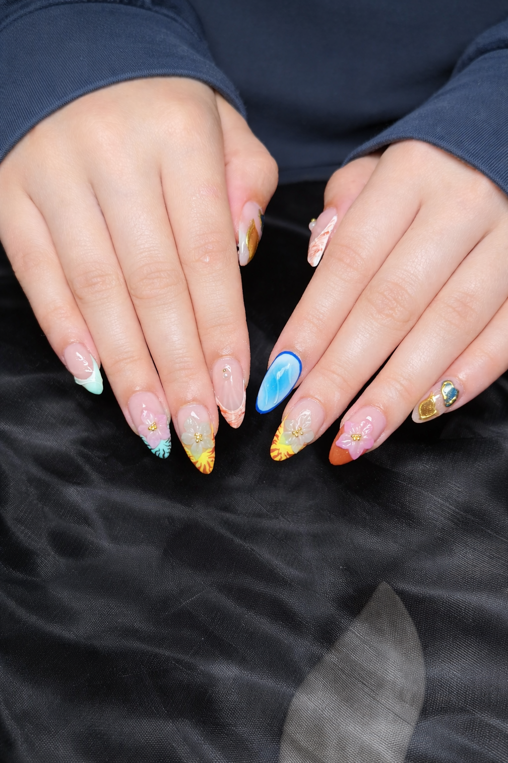 trendy easter nails with pastel swirl design and glitter tips, long almond spring nail