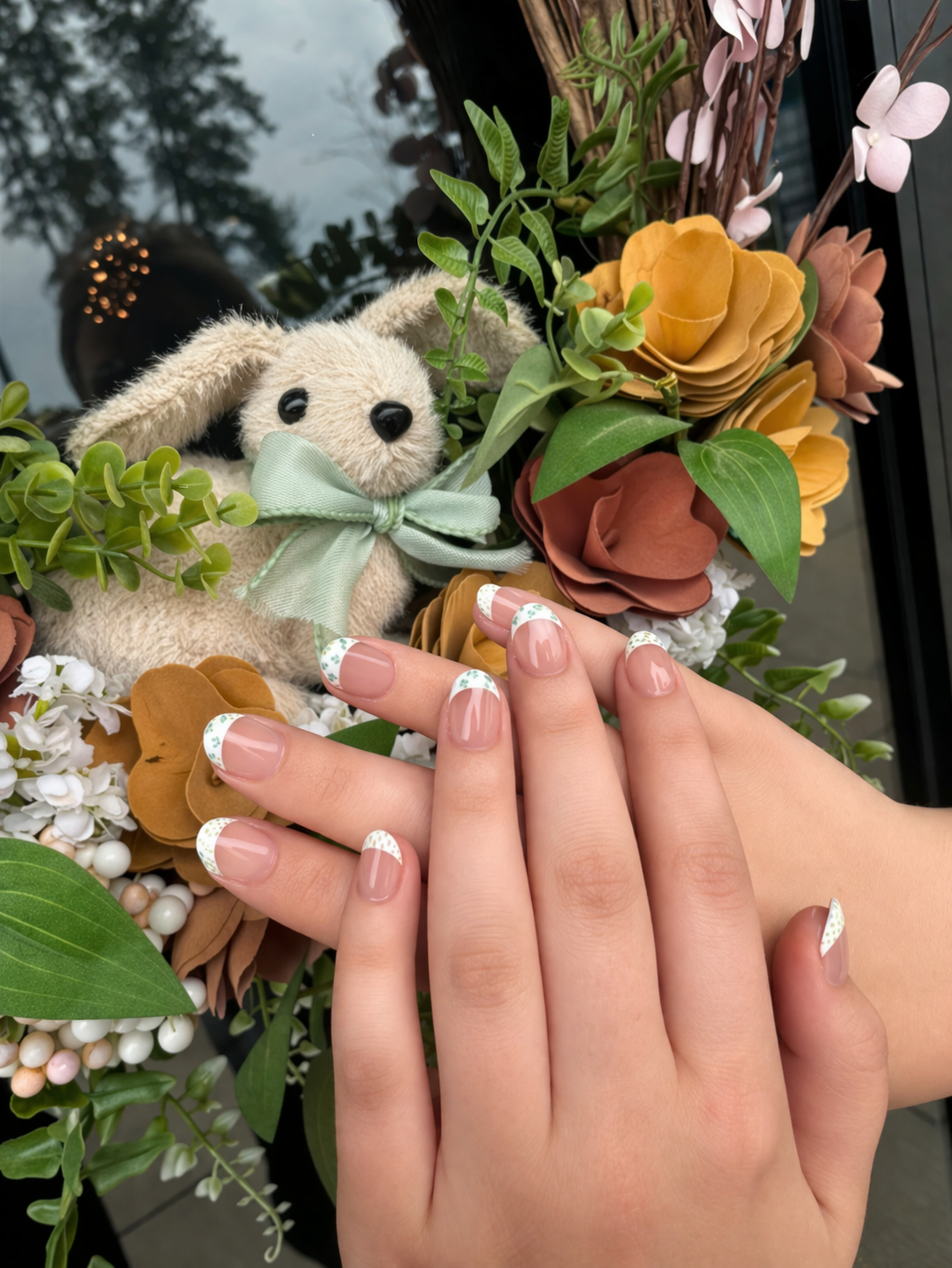natural wedding nails with soft nude base and minimal design, elegant bridal manicure with floral background