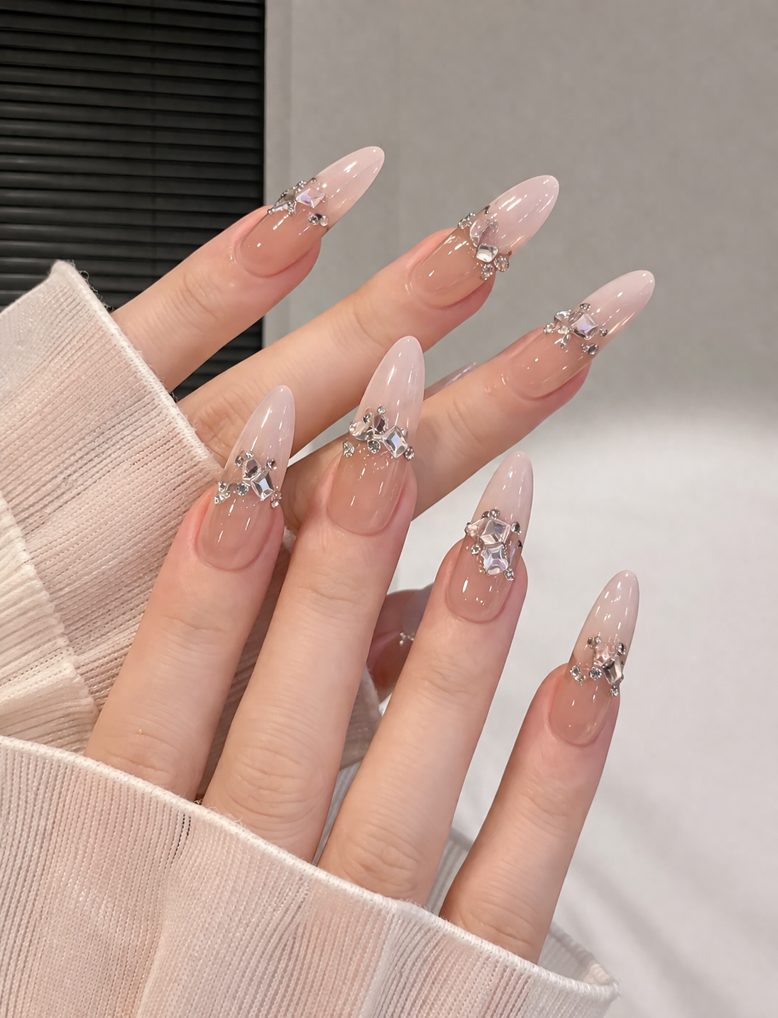 Show-stopping 3D Crystal Cluster Nails by Plush Nail Bar. Precision-placed large diamond-like stones and crystals create a luxurious, jewelry-like finish on tapered coffin extensions. The ultimate statement manicure