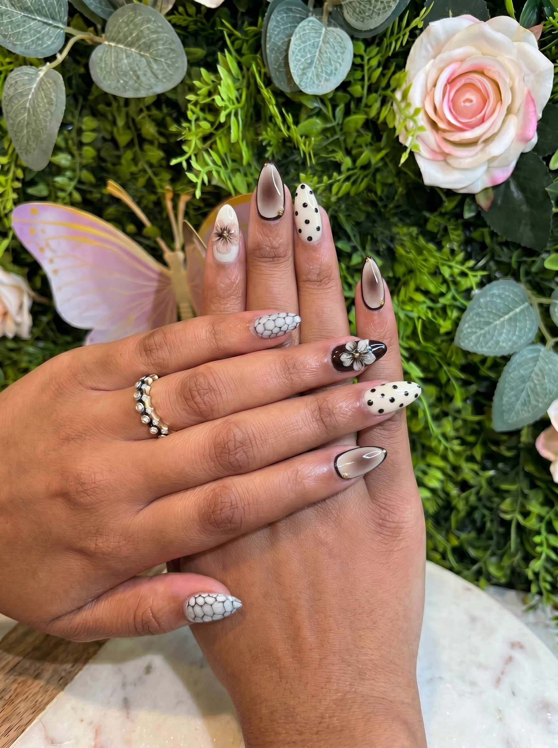 Summer Nail Trends 2026 featuring minimalist floral nail art with white flowers and polka dot accents at Plush Nail Bar