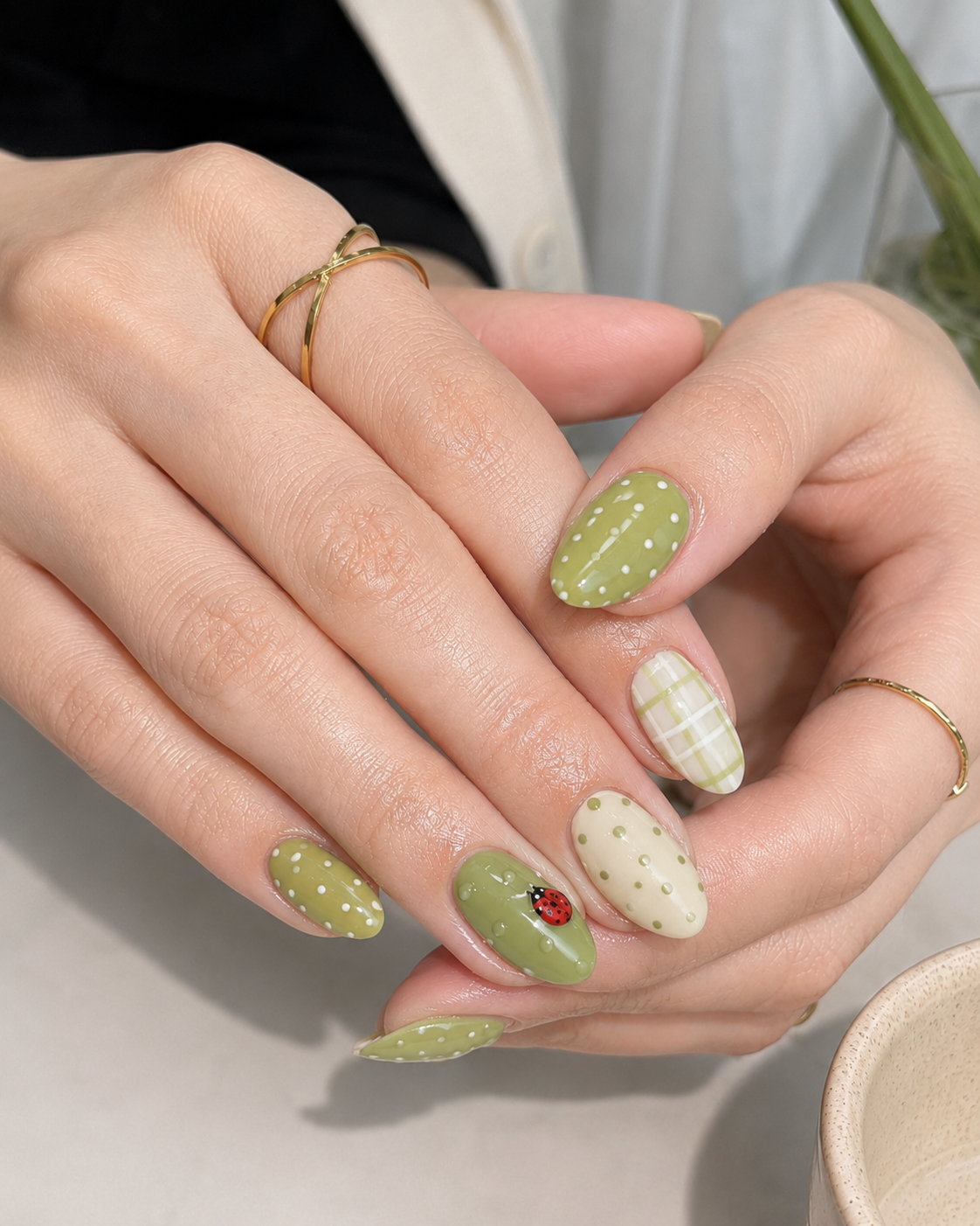 10 Matcha Nails Ideas for a Fresh, Elegant Green Manicure 1 Matcha green mix-and-match almond nails with plaid, polka dots, and tiny fruit nail art.