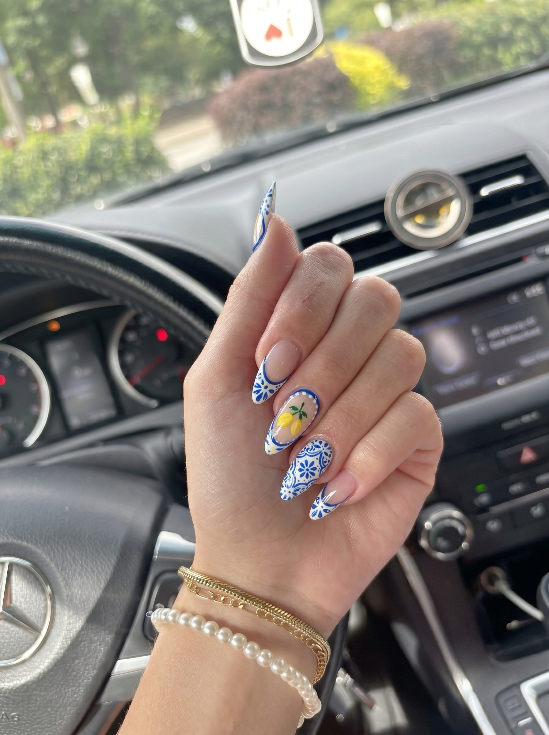 Mediterranean Lemon Nails featuring blue floral nail art and hand-painted lemons