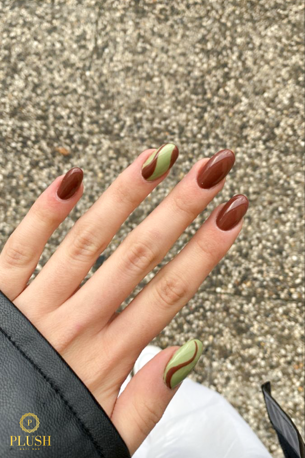 10+ Brown Nail Ideas for a Chic Autumn Look 1 Almond-shaped brown nails with olive green swirl accents, glossy finish, fall-inspired nail art.
