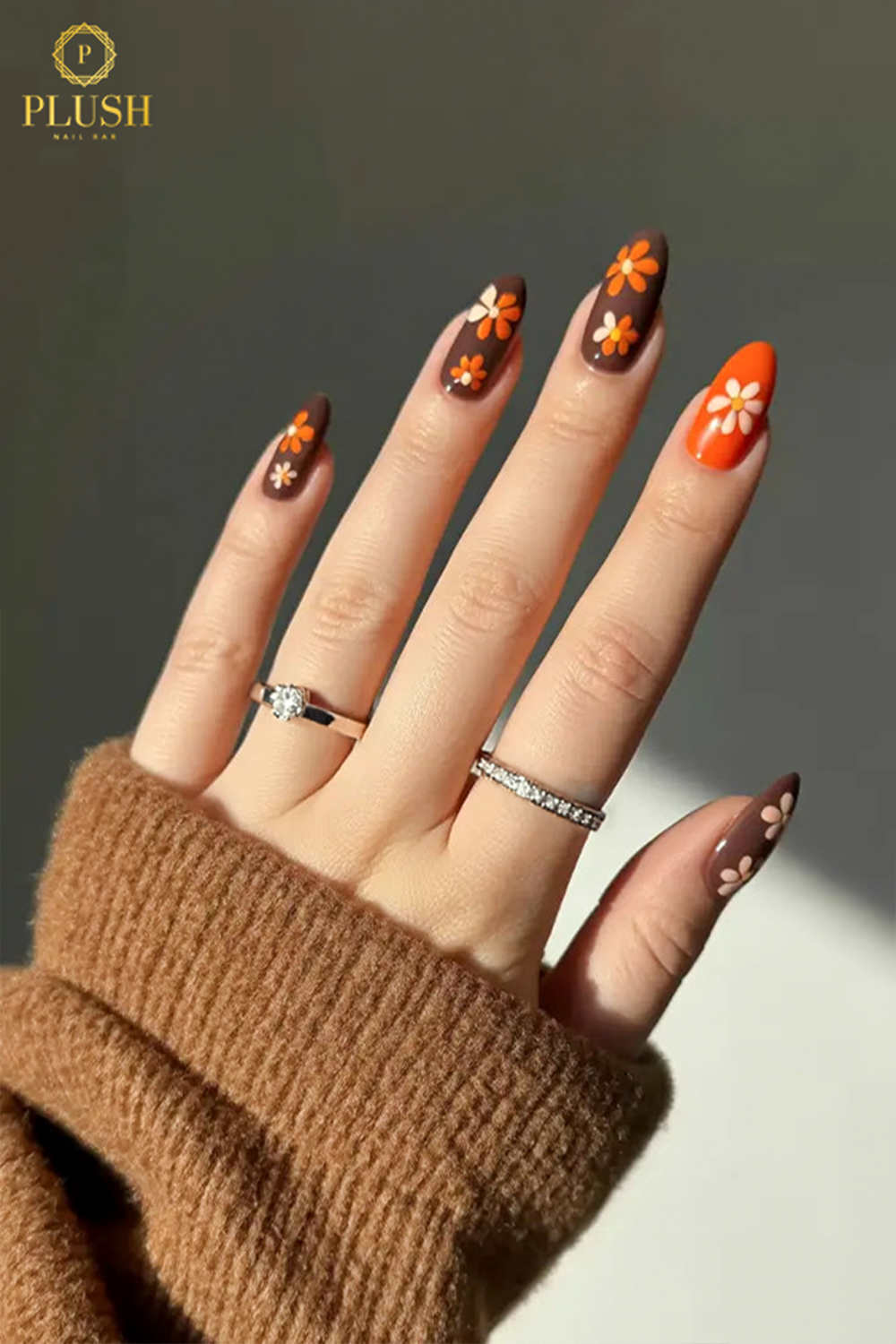 10+ Brown Nail Ideas for a Chic Autumn Look 2 Matte espresso brown nails with orange daisy floral design, perfect for cozy fall vibes.