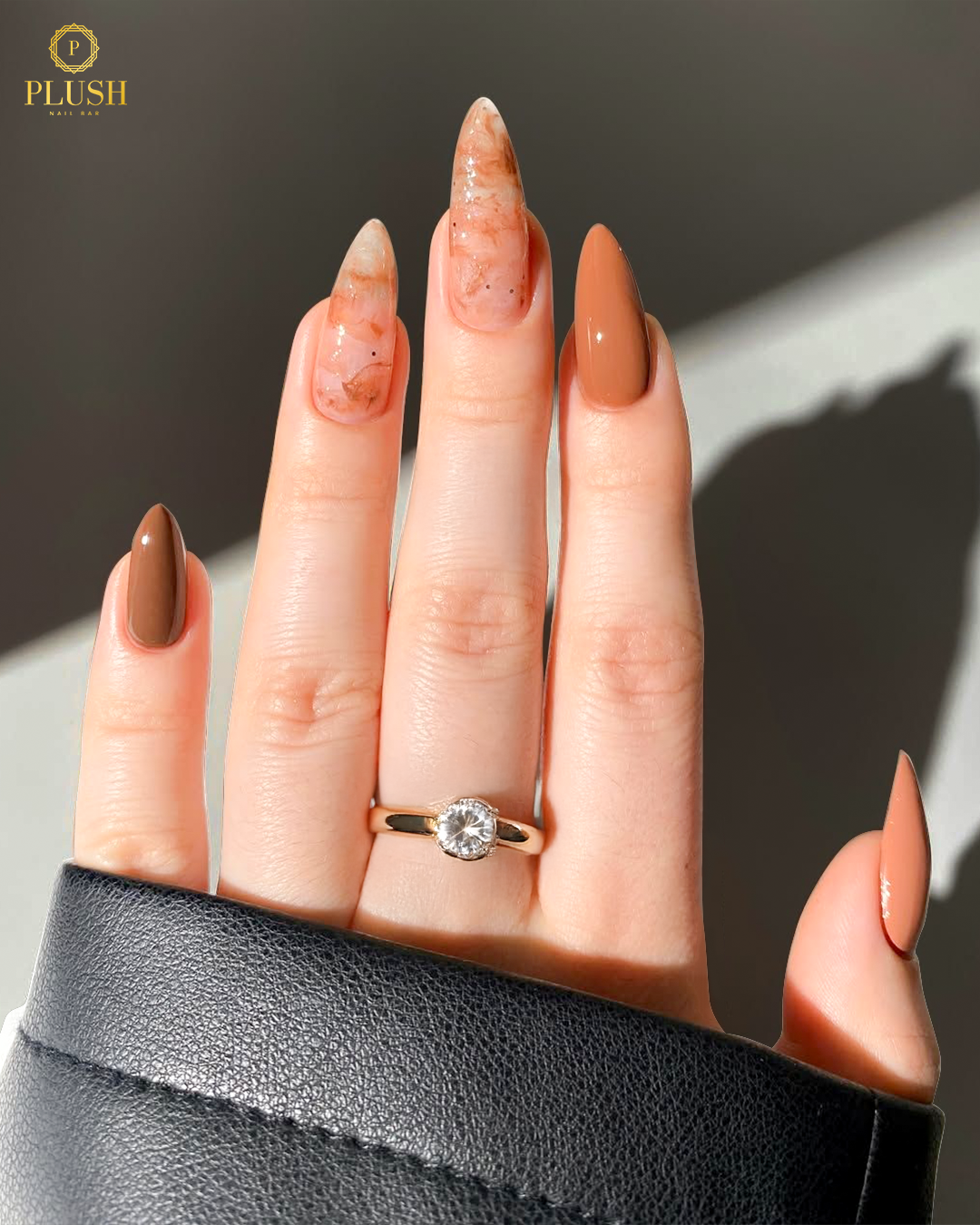 10+ Brown Nail Ideas for a Chic Autumn Look 5 Latte-inspired marble nails with caramel brown polish and stiletto shape, glossy finish.