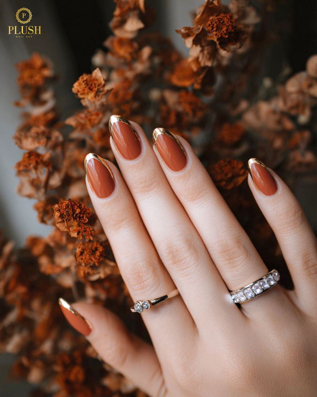 10+ Brown Nail Ideas for a Chic Autumn Look 10 Burnt sienna brown nails with soft gold foil French tips, fall elegance meets simplicity.