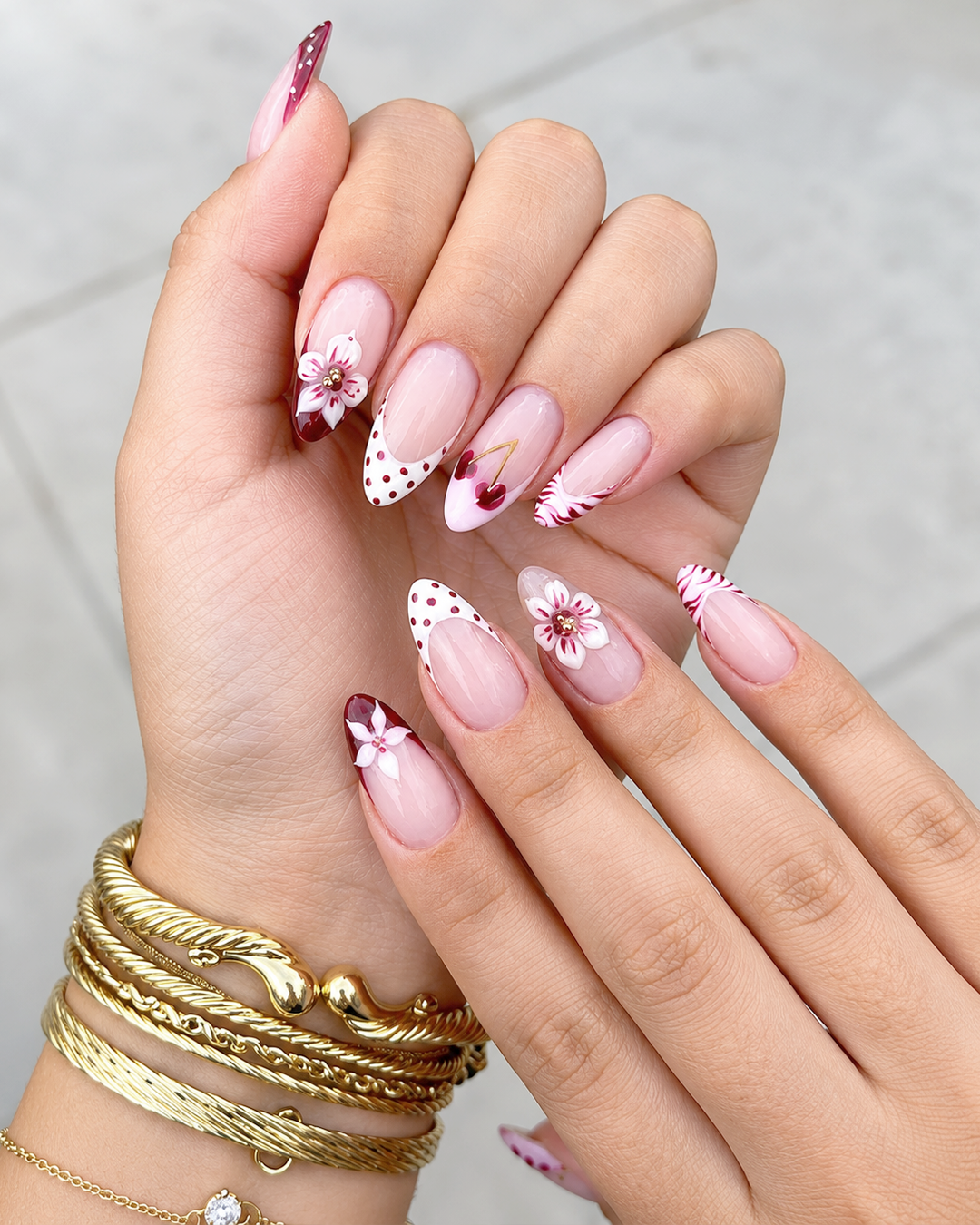 Cherry and floral nail art with red polka dot French tips