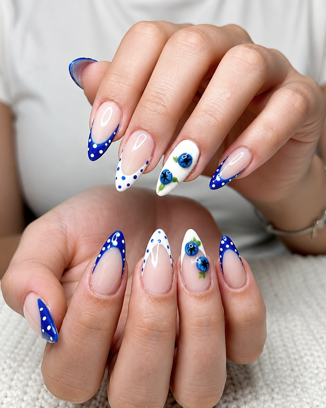 Blueberry nail art with blue and white polka dot French tips