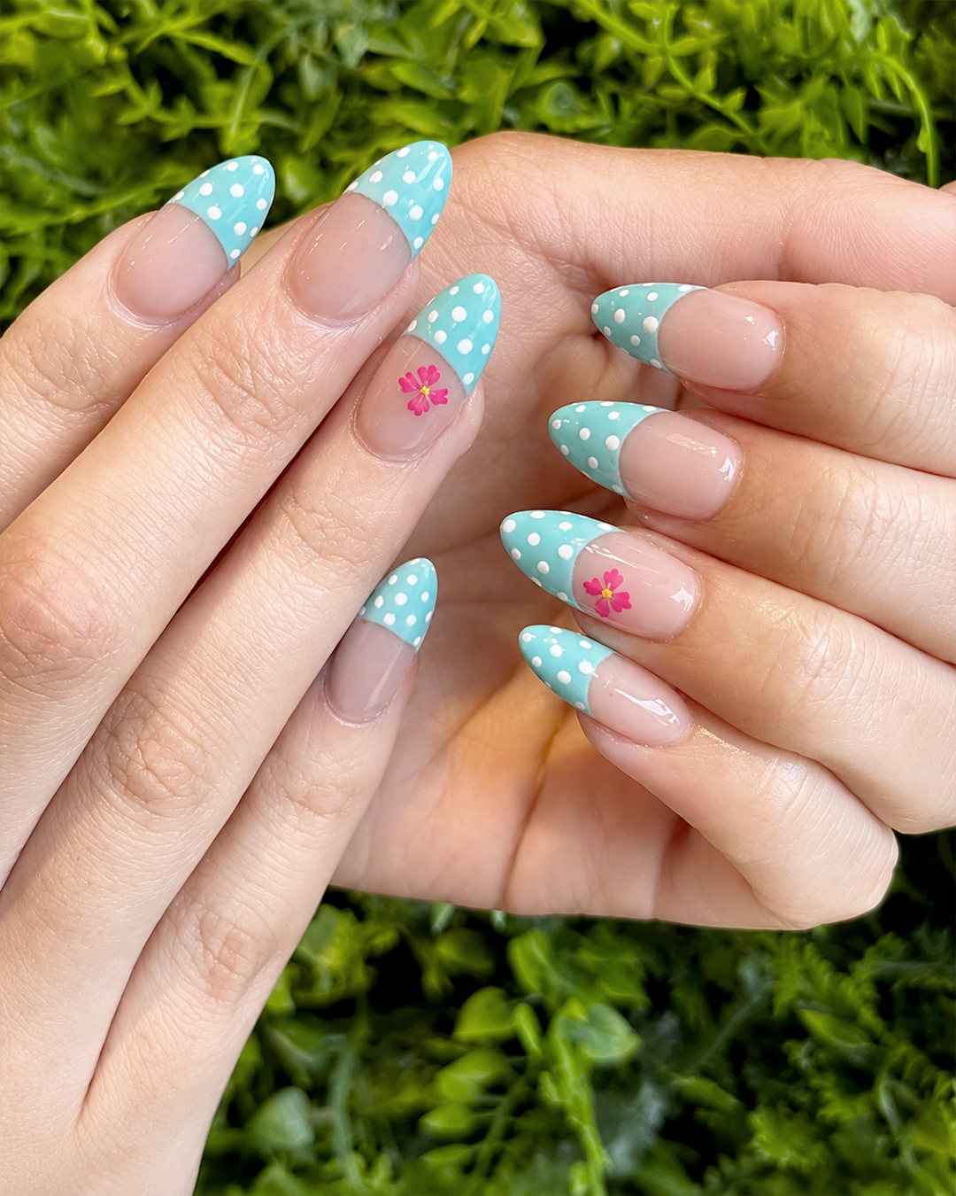 Turquoise French tip nails with white polka dots and pink flowers