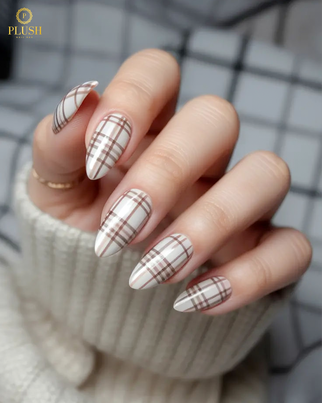 Thanksgiving-inspired plaid nails in soft cream and brown tones, perfect for cozy fall outfits.