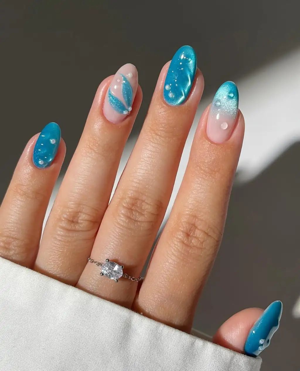3D seashell mermaid nails with pastel blue summer nail art.