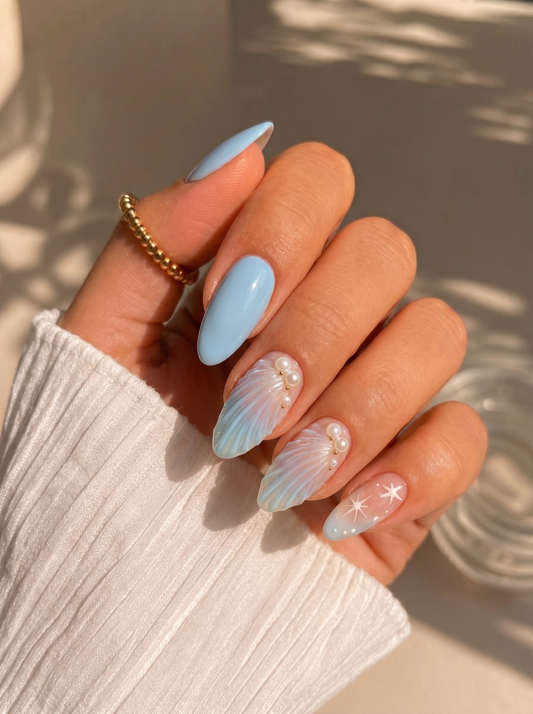 Coastal mermaid nails with seashell accents and elegant almond shape