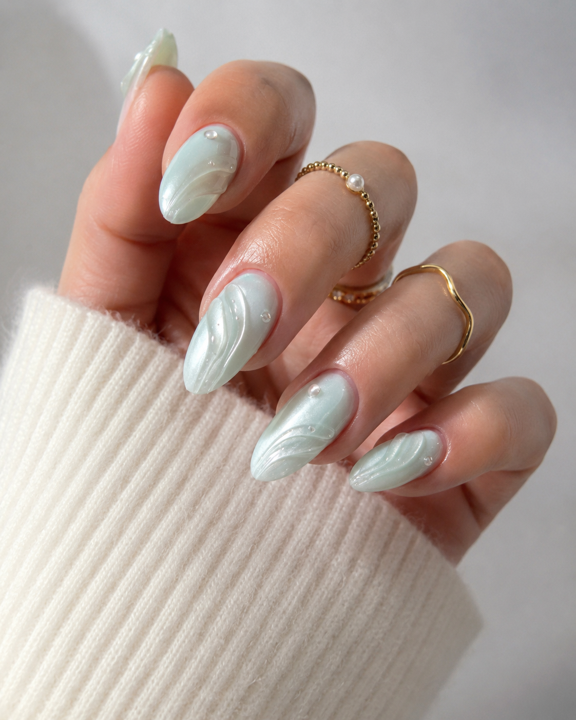 Luxury seashell mermaid nails in soft ocean blue tones.