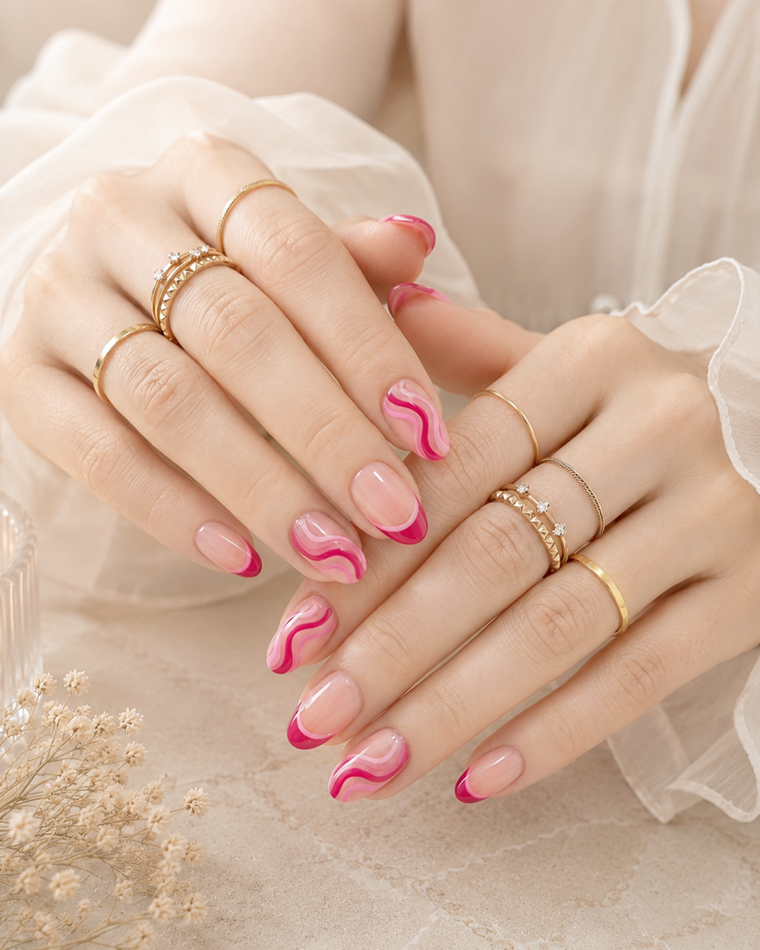 Pink swirl nail design featuring flowing abstract lines.