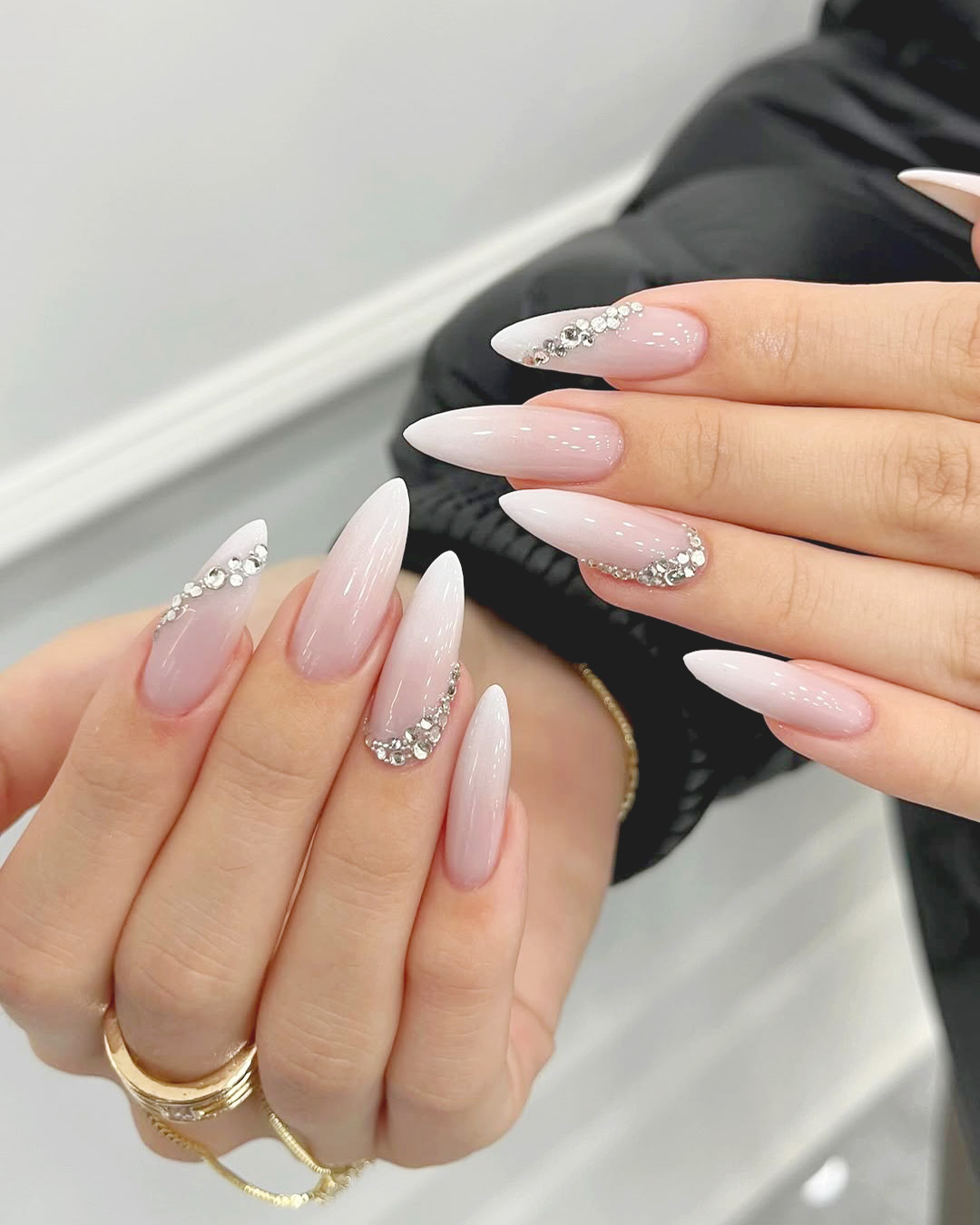 luxury wedding nails with rhinestones and glossy nude pink base, long almond bridal nail design