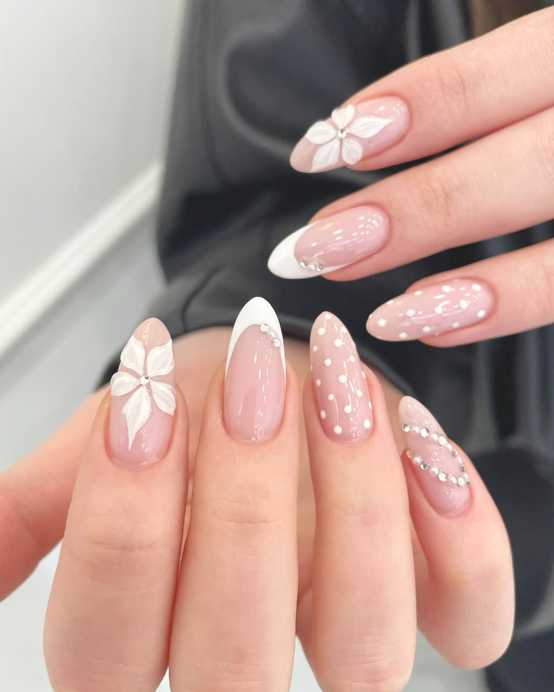 cute wedding nails with white flowers and polka dot design, glossy pink bridal manicure