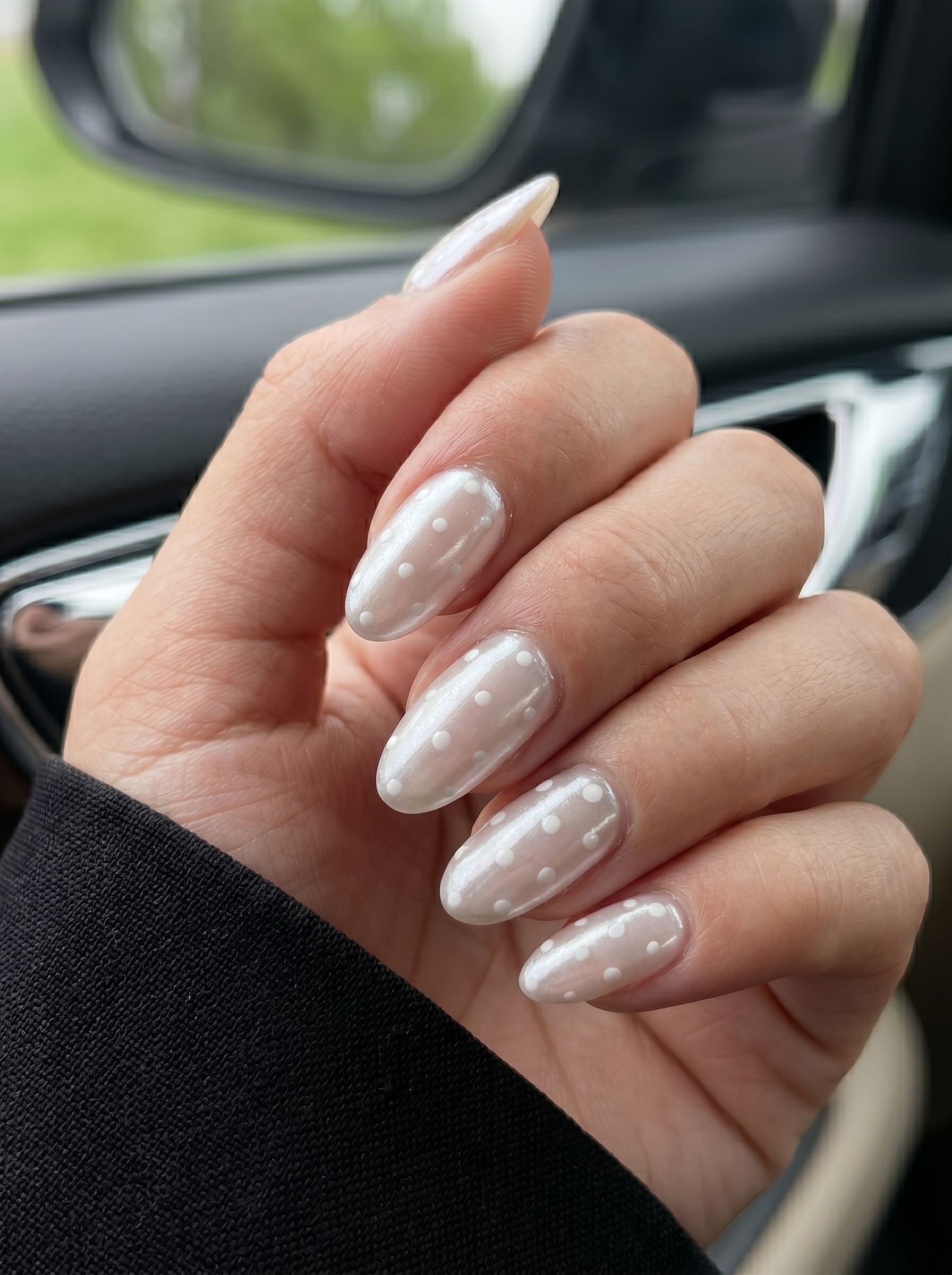 White Chrome Nails: The Stunning Trend Everyone Is Wearing in 2026 3 Glazed white chrome nails with delicate white polka dots and a pearlescent finish.