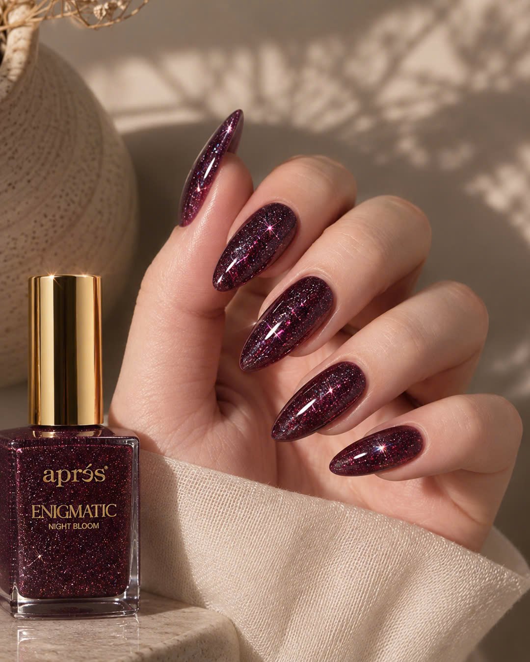 HEMA-Free Gel Manicure: Meet the Apres Upgrade at Plush Nail Bar 4 Plum glitter almond nails in Apres Enigmatic Night Bloom next to the bottle