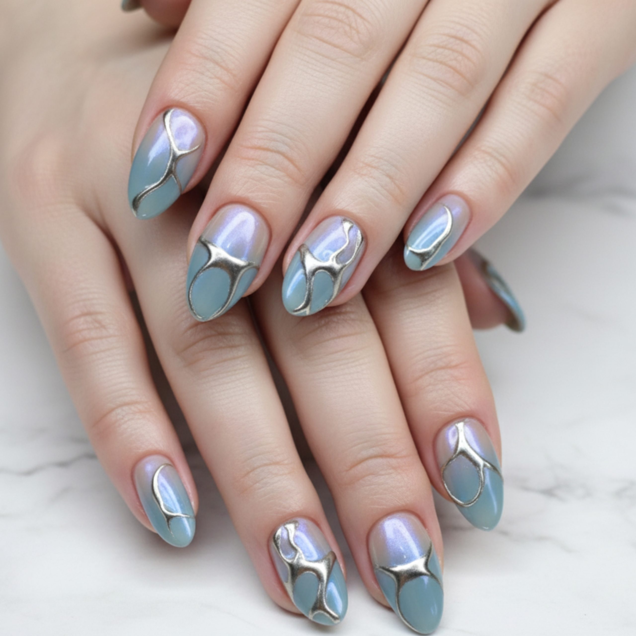 TikTok-inspired homecoming nails in pastel blue and lavender chrome with silver abstract metal accents on short almond-shaped nails.