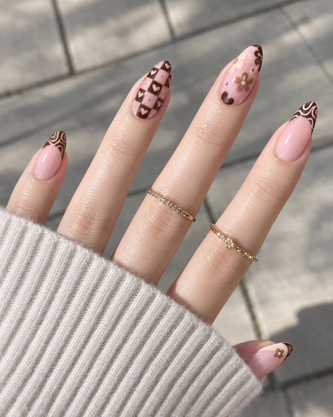 Plaid Nails Bring Sweater Weather Straight to Your Hands 1 Brown checkerboard, retro daisy and swirl French nails over a soft pink base