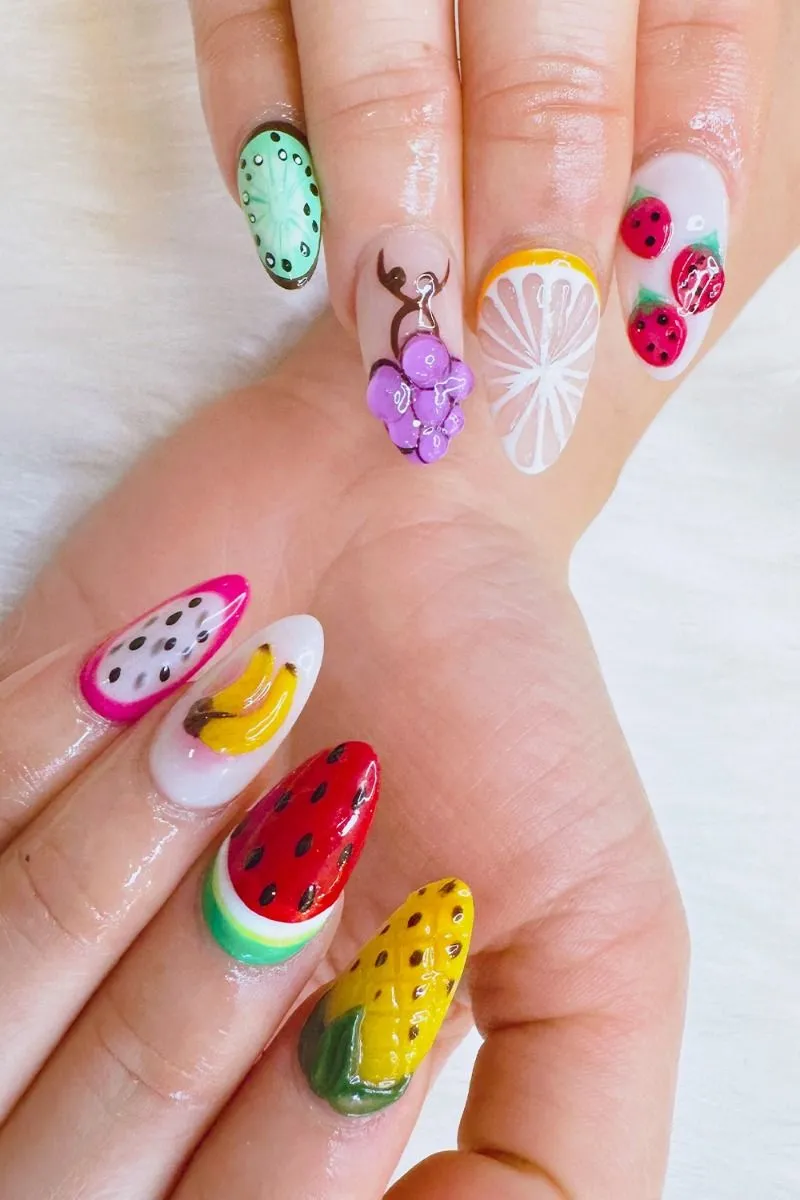 Vibrant 3D fruit nails with watermelon, pineapple, banana, and citrus designs